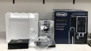 De'Longhi Dinamica Plus unboxed with plastic wrapping and polystyrene