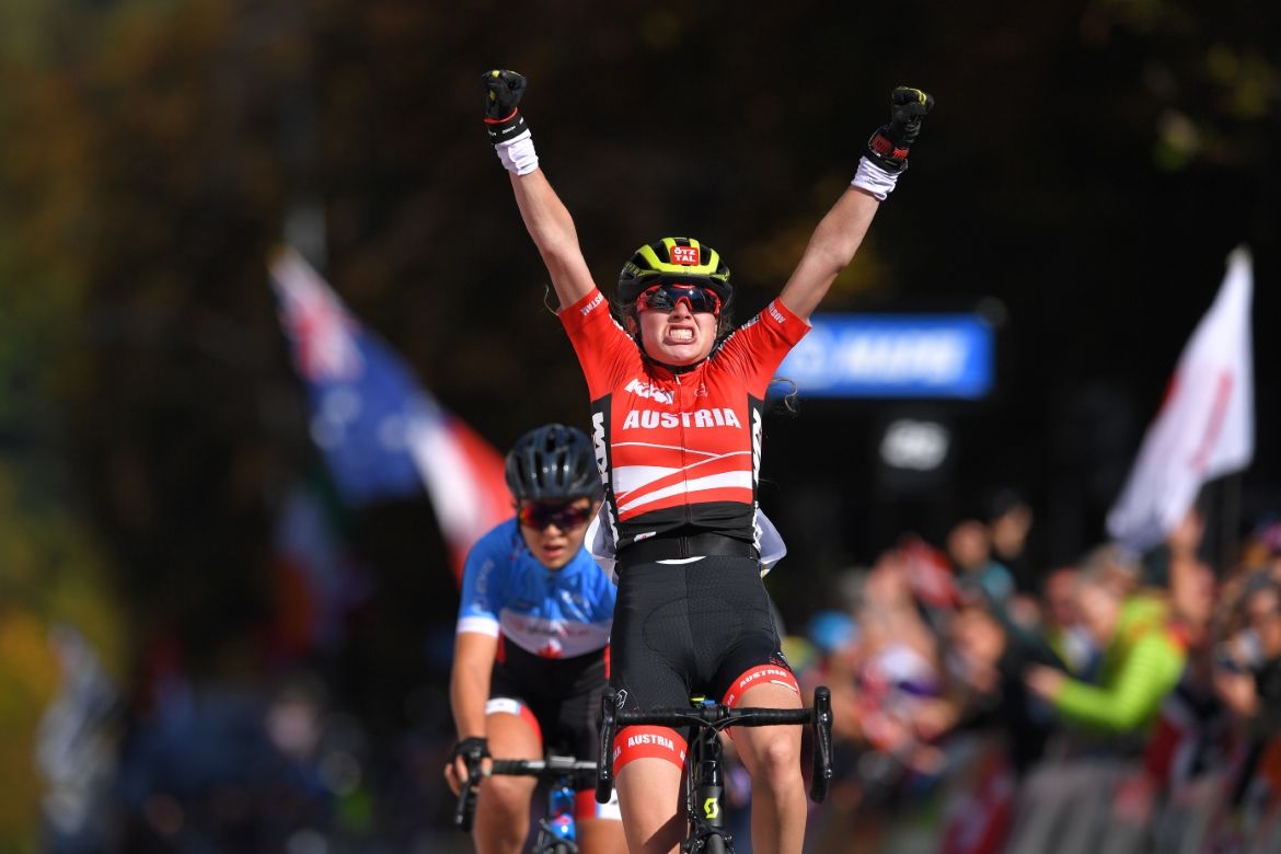 Laura Stigger raises her arms in celebration