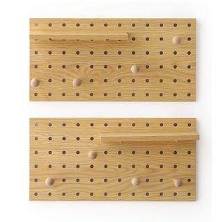 Two wooden pegboards on a white background