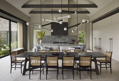 open plan dining living kitchen space with modern pendant lighting