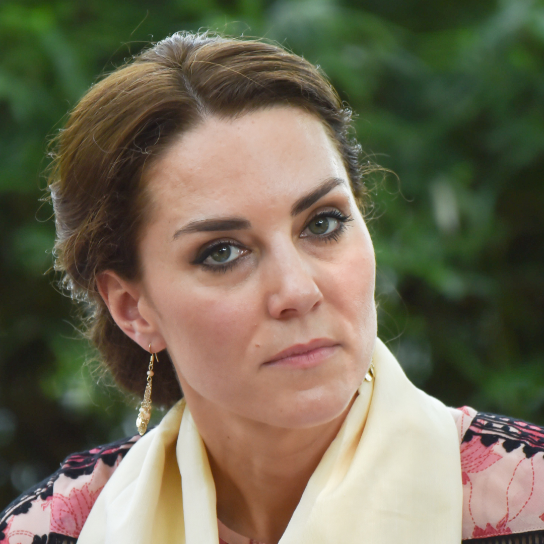 A headshot of Princess Kate wearing a yellow scarf around her neck and pink patterned dress
