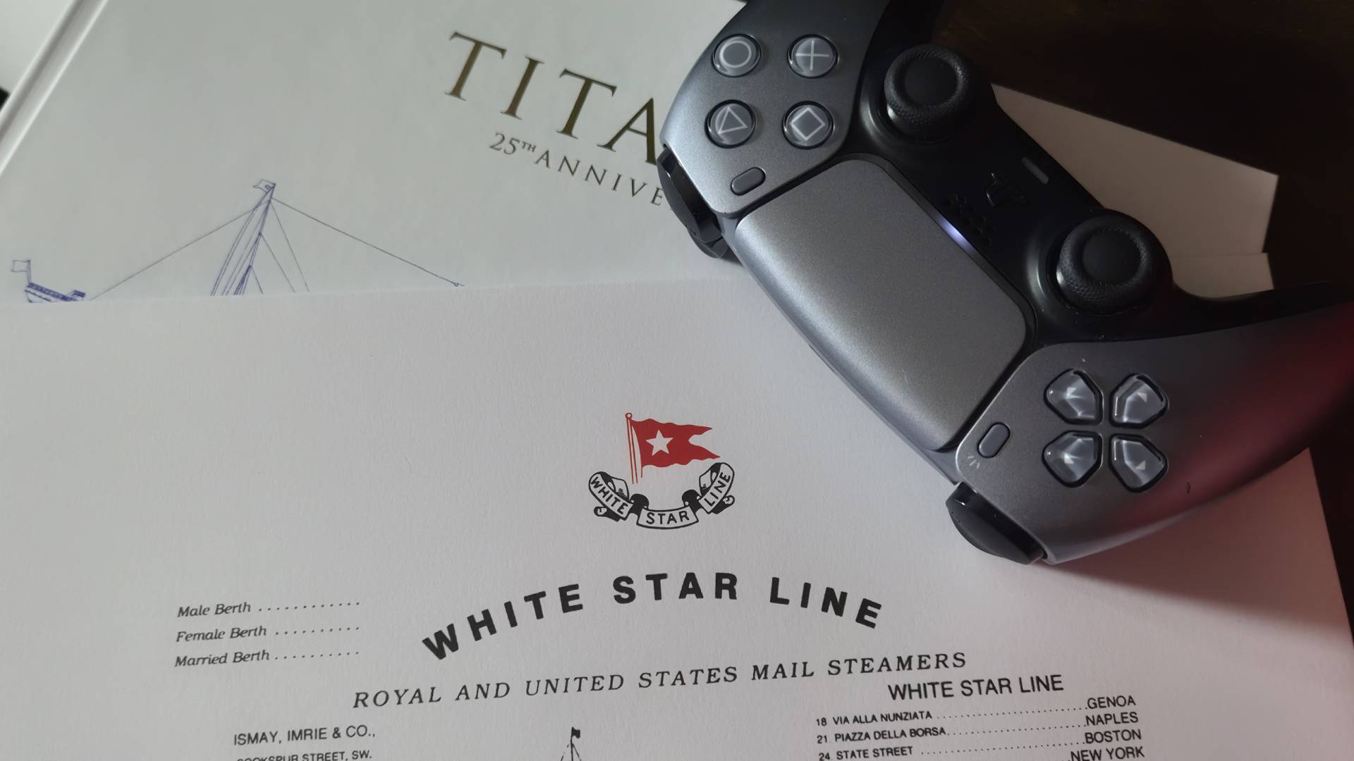 Close up of the contents of the Titanic 4K UHD Blu-ray with a DualSense controller sitting on top.