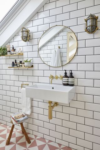 a loft conversion bathroom with a white metro tiled wall