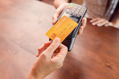 Person paying with a credit card using a credit card terminal