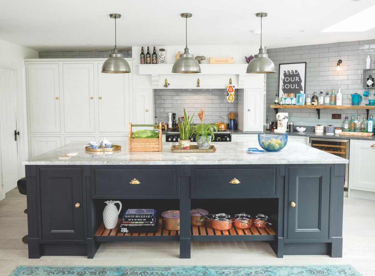 A 3m-long kitchen island, painted in Farrow &amp; Ball No.31 Railings and topped with white Brazilian marble, creates a dramatic focal point.