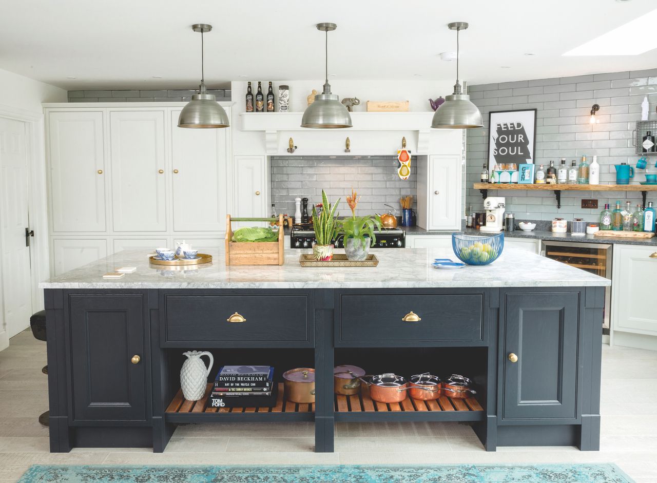 A 3m-long kitchen island, painted in Farrow &amp; Ball No.31 Railings and topped with white Brazilian marble, creates a dramatic focal point.