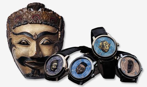 a wooden theatrical mask with 4 watches with different masks in the faces