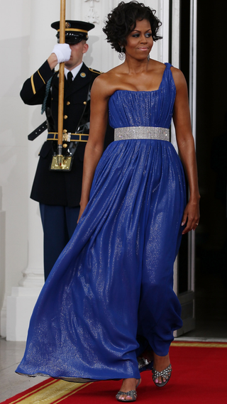 First lady Michelle Obama walks with her husband U.S President Barack Obama to greet Mexican President Felipe Calderon and his wife Margarita Zavala for a State Dinner at the White House on May 19, 2010 in Washington, DC