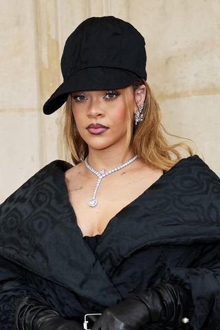 Rihanna is pictured with warm blonde/brown hair whilst attending the Dior Haute Couture show during Paris Fashion Week Spring/Summer 2024 at Musee Rodin on January 22, 2024 in Paris, France.