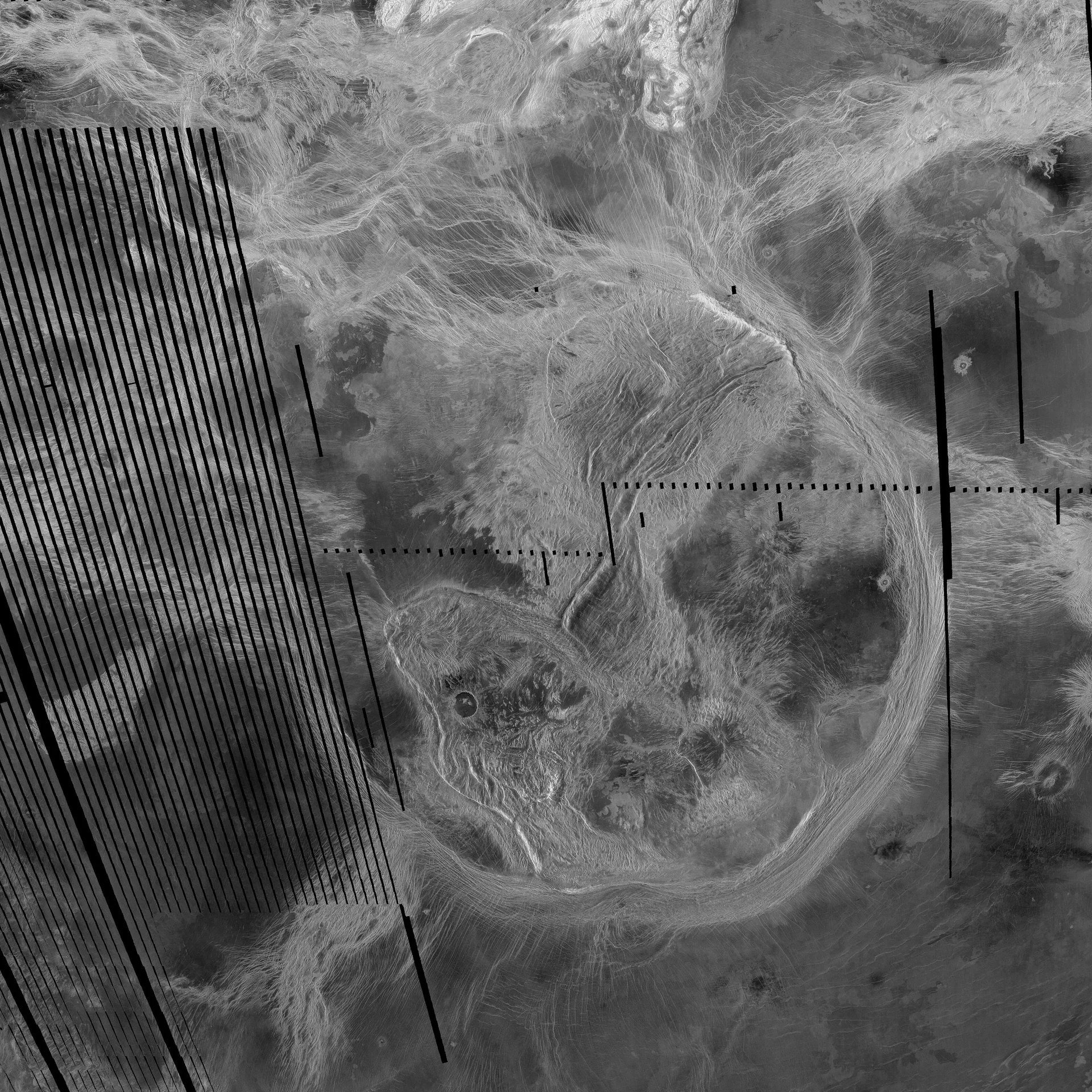 A grayscale image of the surface of Venus, showing various shapes.