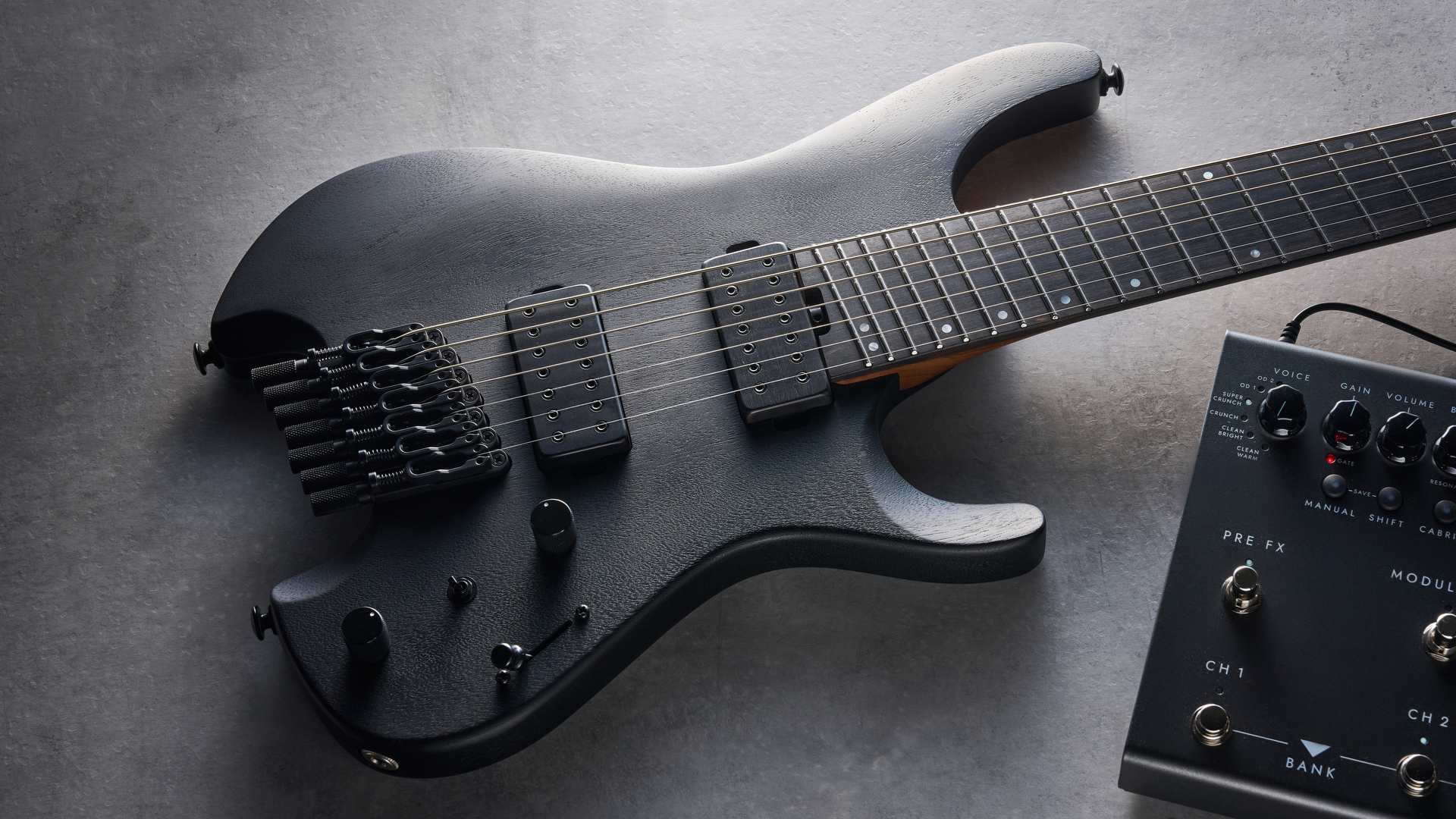 Ibanez QX527B headless guitar shot on grey surface