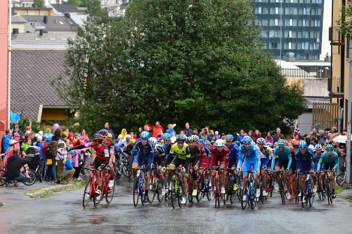 The peloton rounds a corner to start climbing