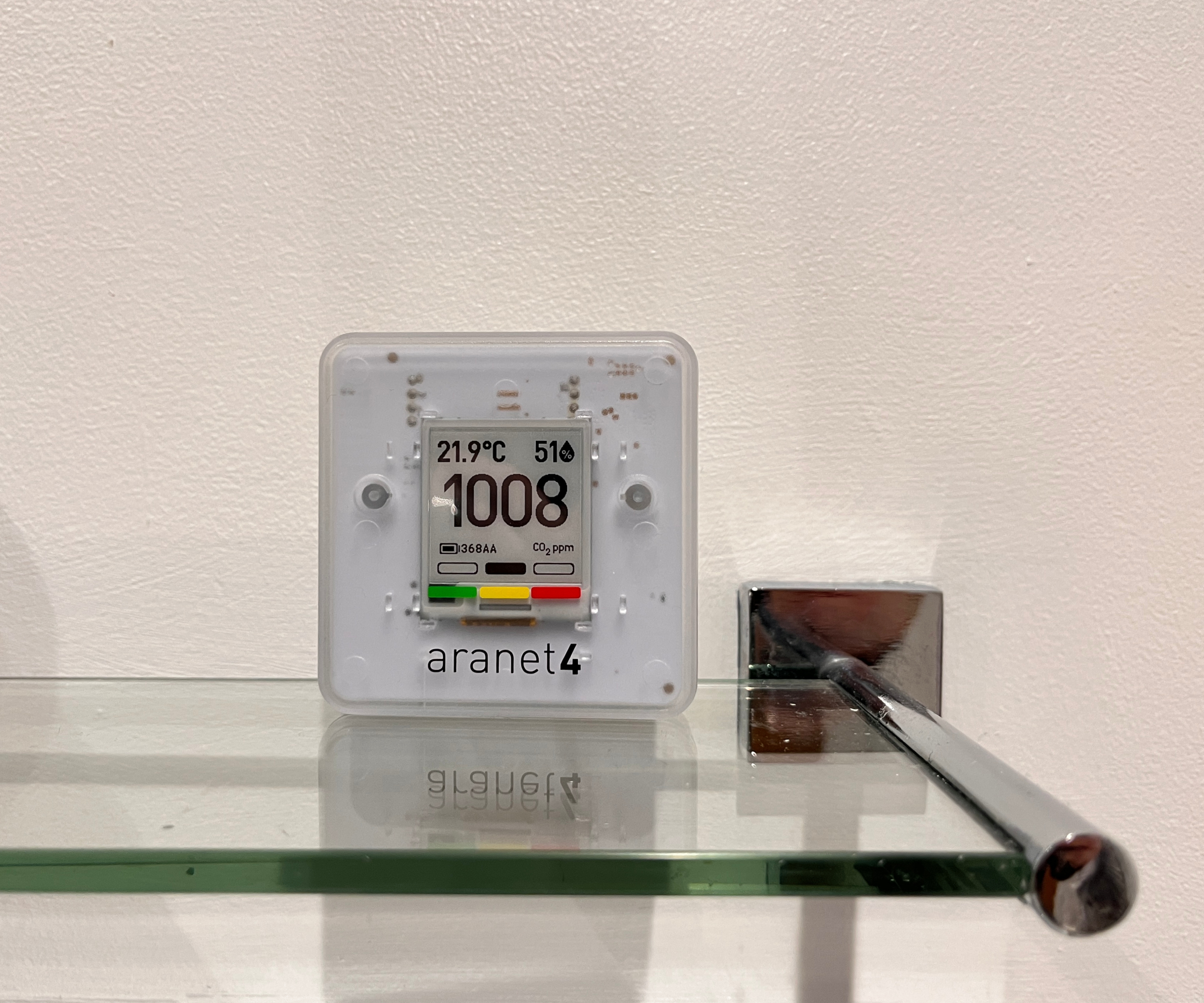 Aranet4 Home monitor on glass and chrome bathroom shelf