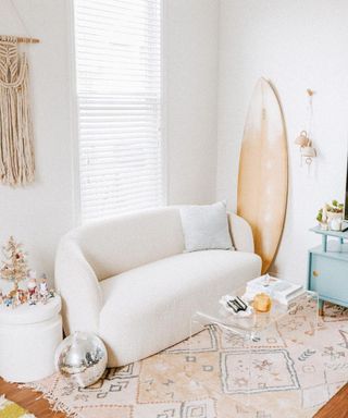 China Frost instagram photo of her living room with white boucle couch, glass coffee table