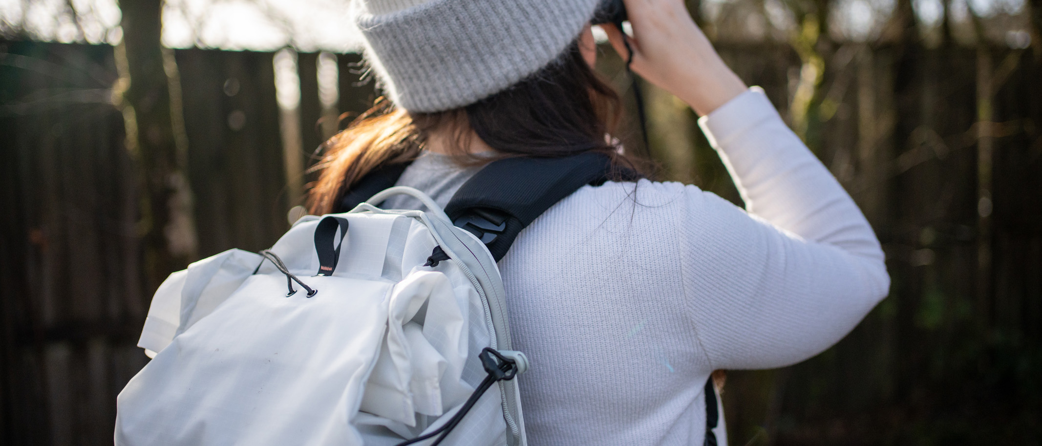 A Peak Design outdoor backpack being worn on the author's back.