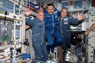 The Soyuz 2 crewmembers — American businessman Dennis Tito (left) and Russian cosmonauts Talgat Musabayev and Yuri Baturin — pose for a photo in the Zvezda Service Module on the International Space Station, in 2001.