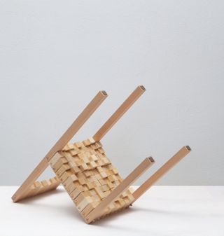 Wooden chair by Zaven shown upside down