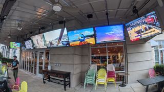 Outdoor area at Buckhead Atlanta restaurant Botica, featuring video displays driven by a Key Digital AV over IP system.