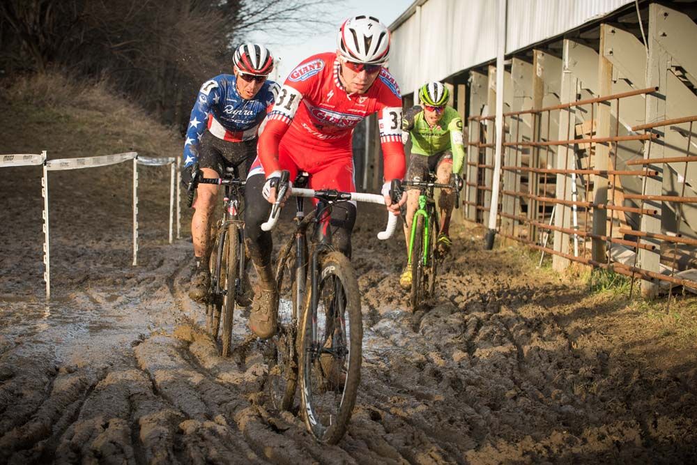Logan Owens (Cal Giant) leads trio Jeremy Powers (Rapha) and Stephen Hyde (Cannondale pb Cyclocrossworld) along the barns and through the mud at the base of Mt. Krumpit