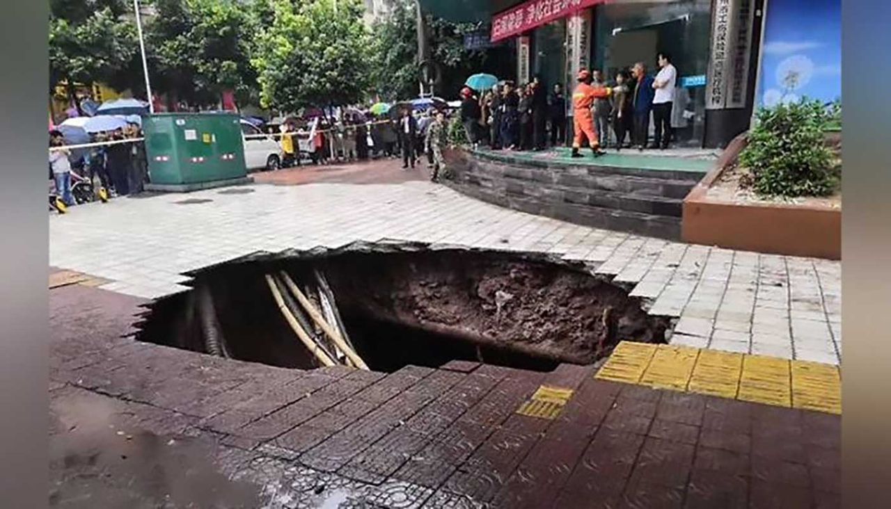 Four people have died after a sinkhole opened up in a busy commercial district in Dahzou, China