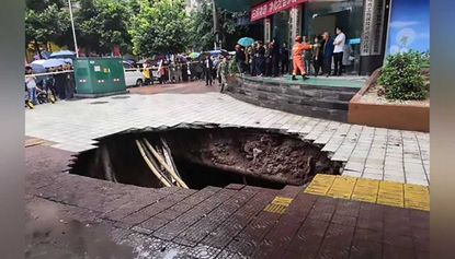 Four people have died after a sinkhole opened up in a busy commercial district in Dahzou, China