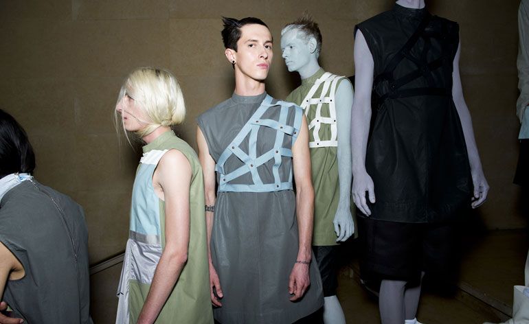 Models on a stairwell, with body paint, one looking at the camera