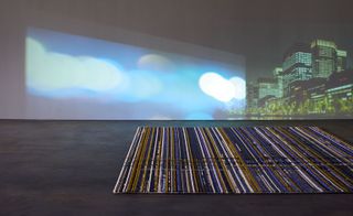 Striped rug with city background on projector