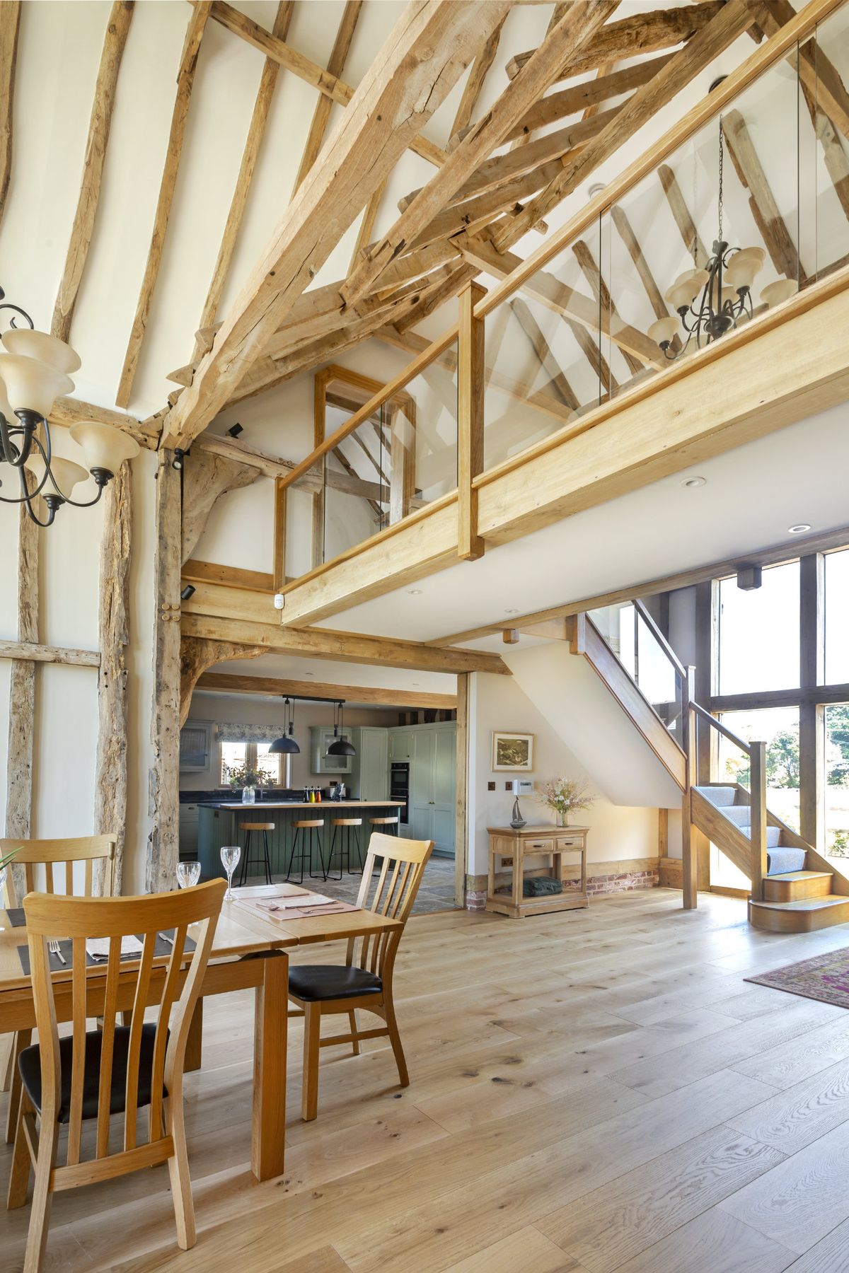 A spacious barn conversion with an internal wooden bridge linking the top floor together