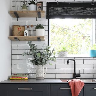 black kitchen with white metro tiles