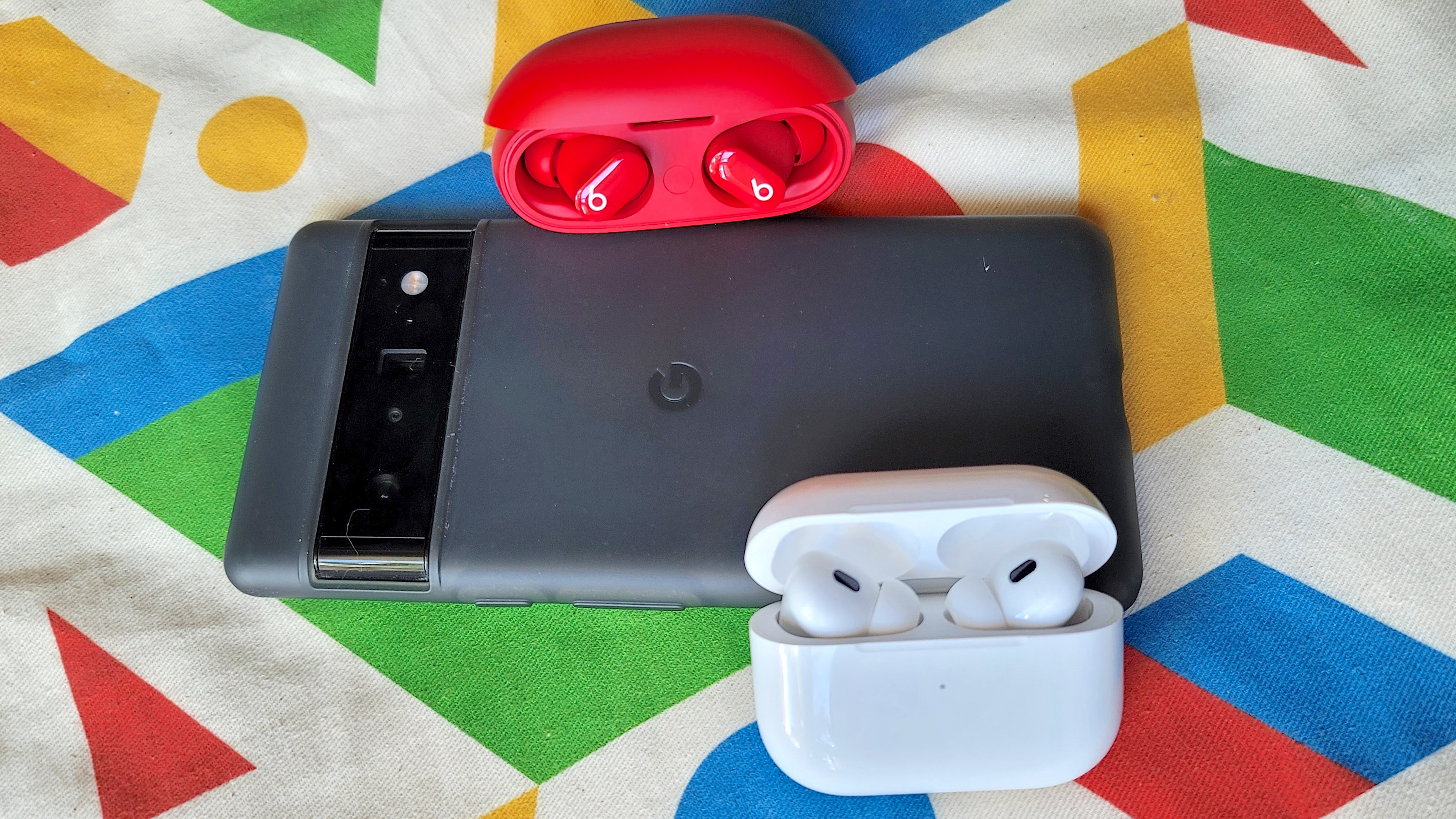 The AirPods Pro 2 and Beats Studio Buds sitting on top of the Google Pixel 6