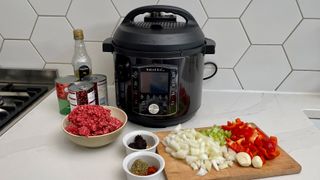 Instant Pot Pro surrounded by ingredients to make a slow cooked chilli