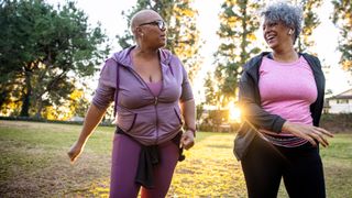 Two older women enjoy a walk outdoors together