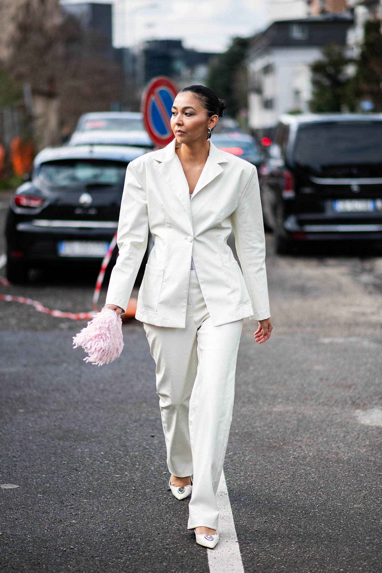 woman wearing a white blazer and white suit pants and white heels