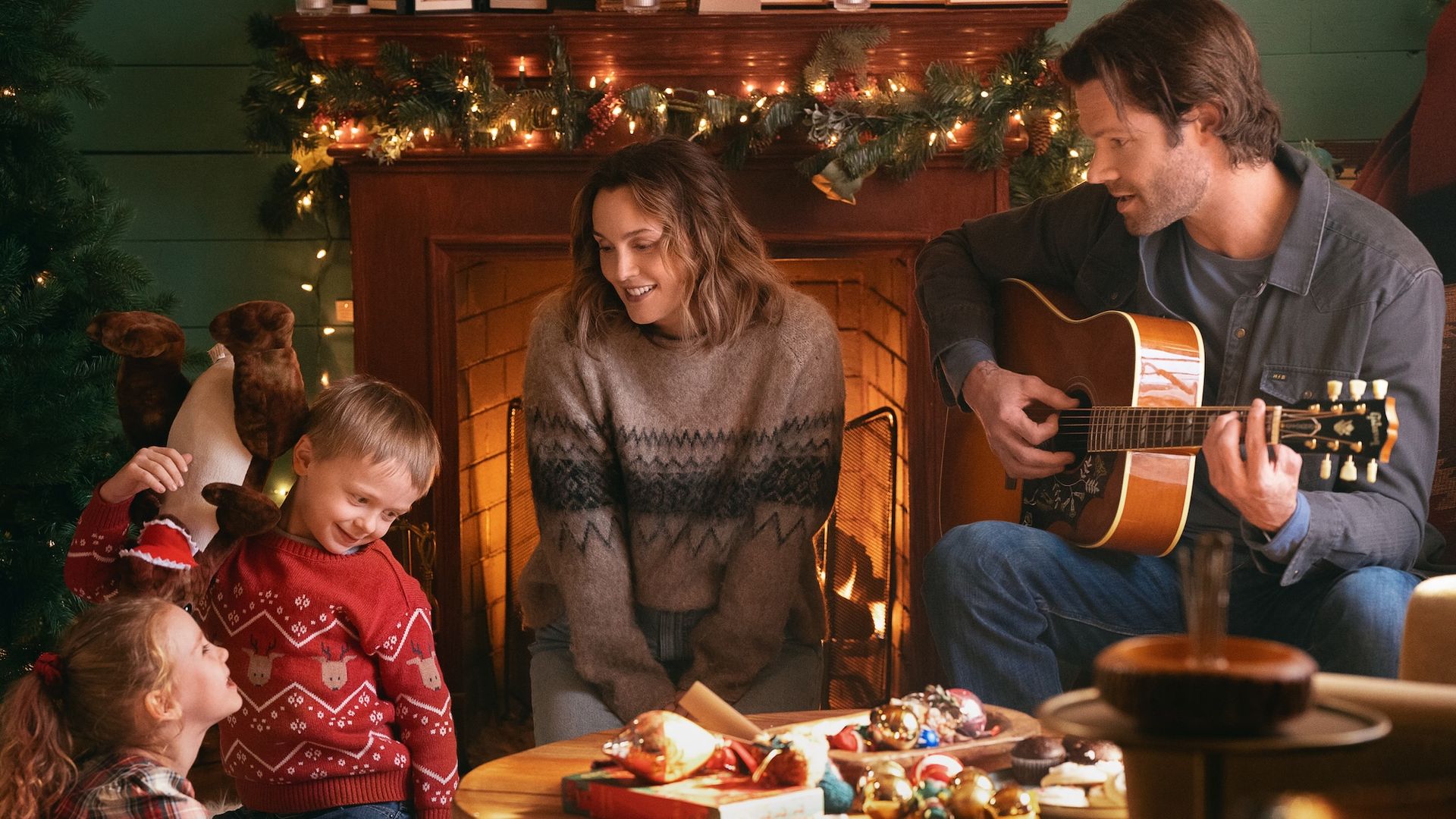 Leighton Meester and Jared Padalecki by the fire with some kids in Guarding Stars