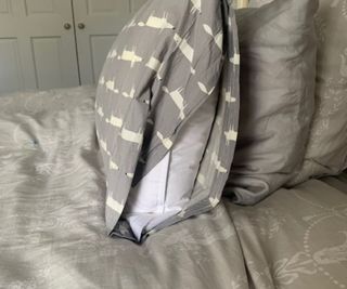The Brooklinen Down Pillow in a pillowcase, from the side