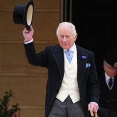 King Charles tipping his hat at a garden party
