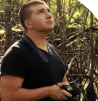 Sean Graesser, man wearing black t-shirt looking up