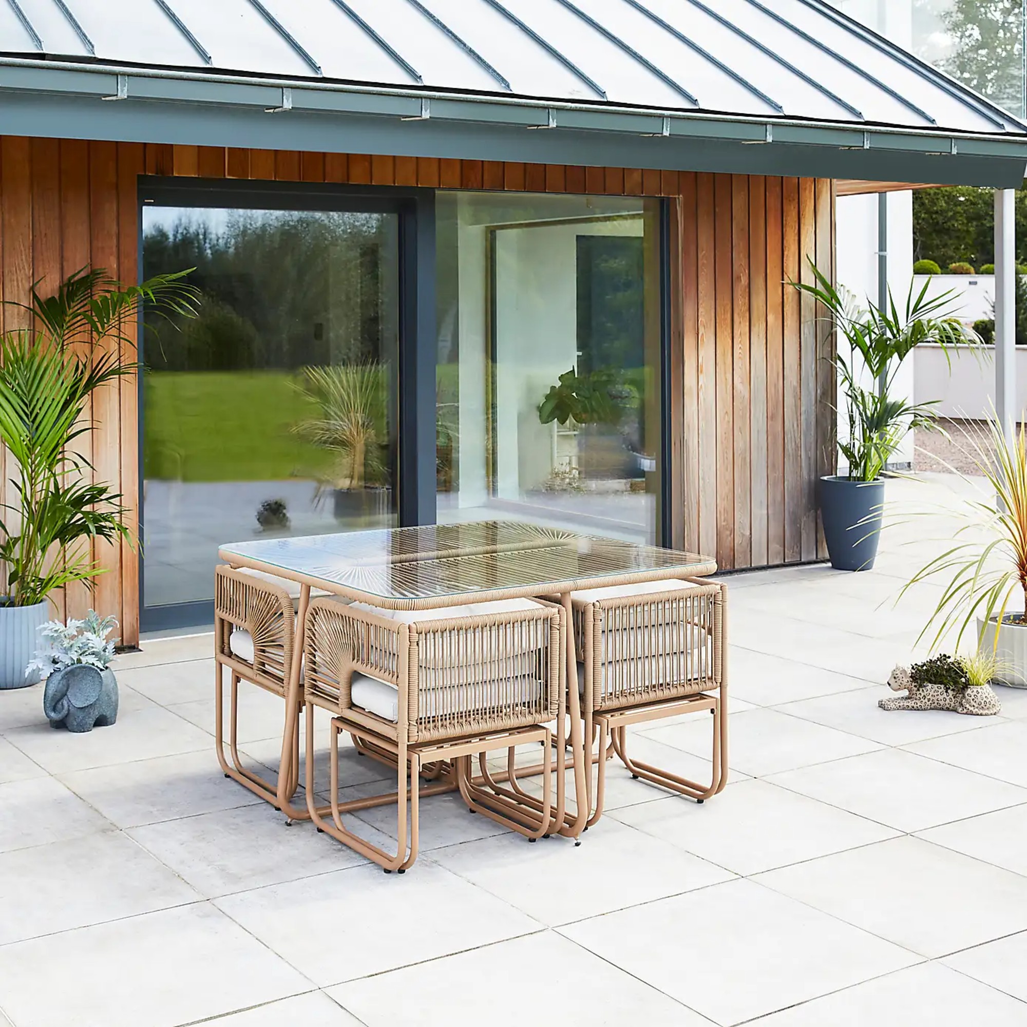 Dunelm Amazonia 8 Seater Cube Garden Dining Set with tucked-in chairs on a patio