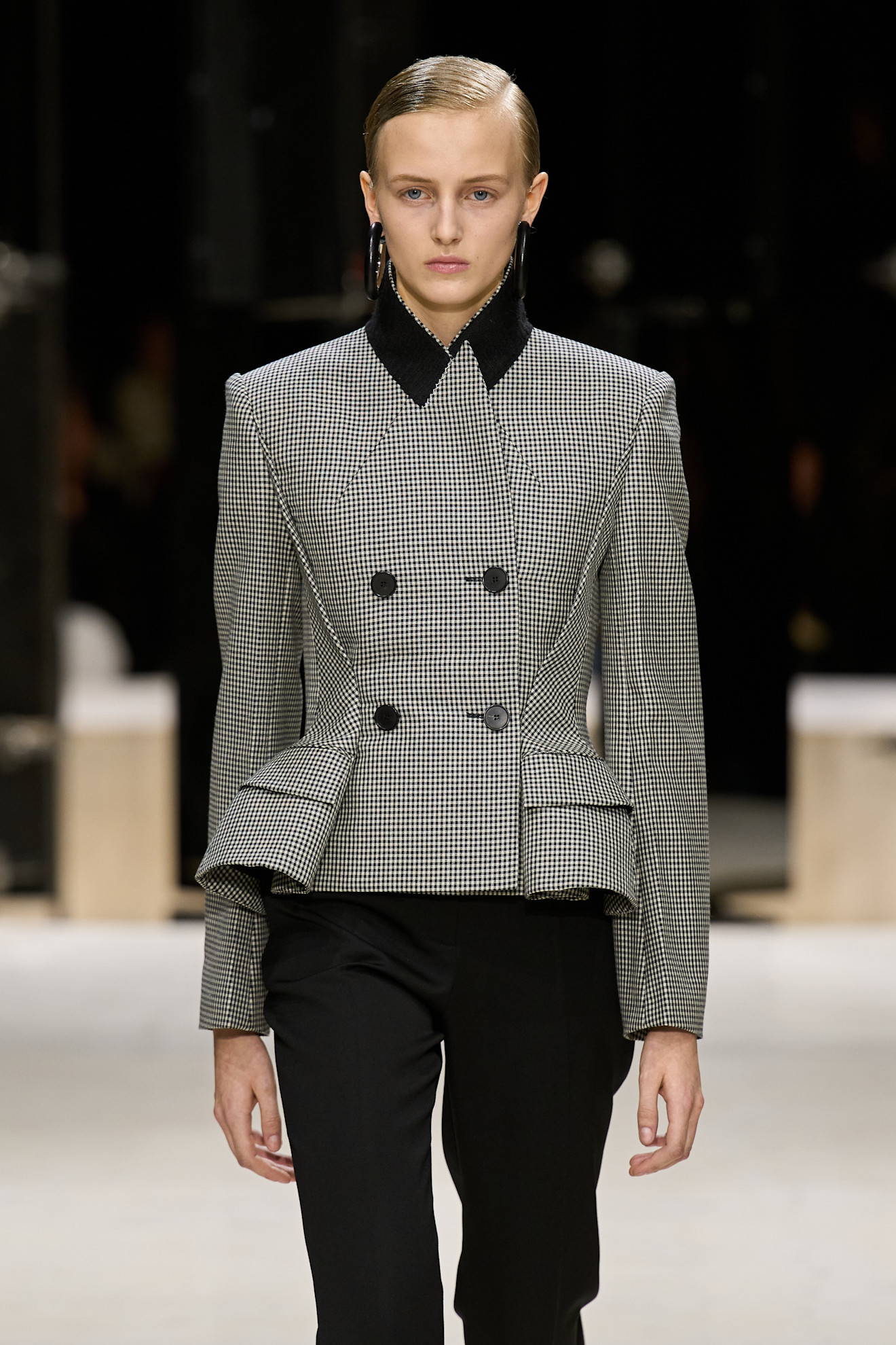 a model wears a peplum jacket on the catwalk at givenchy aw26