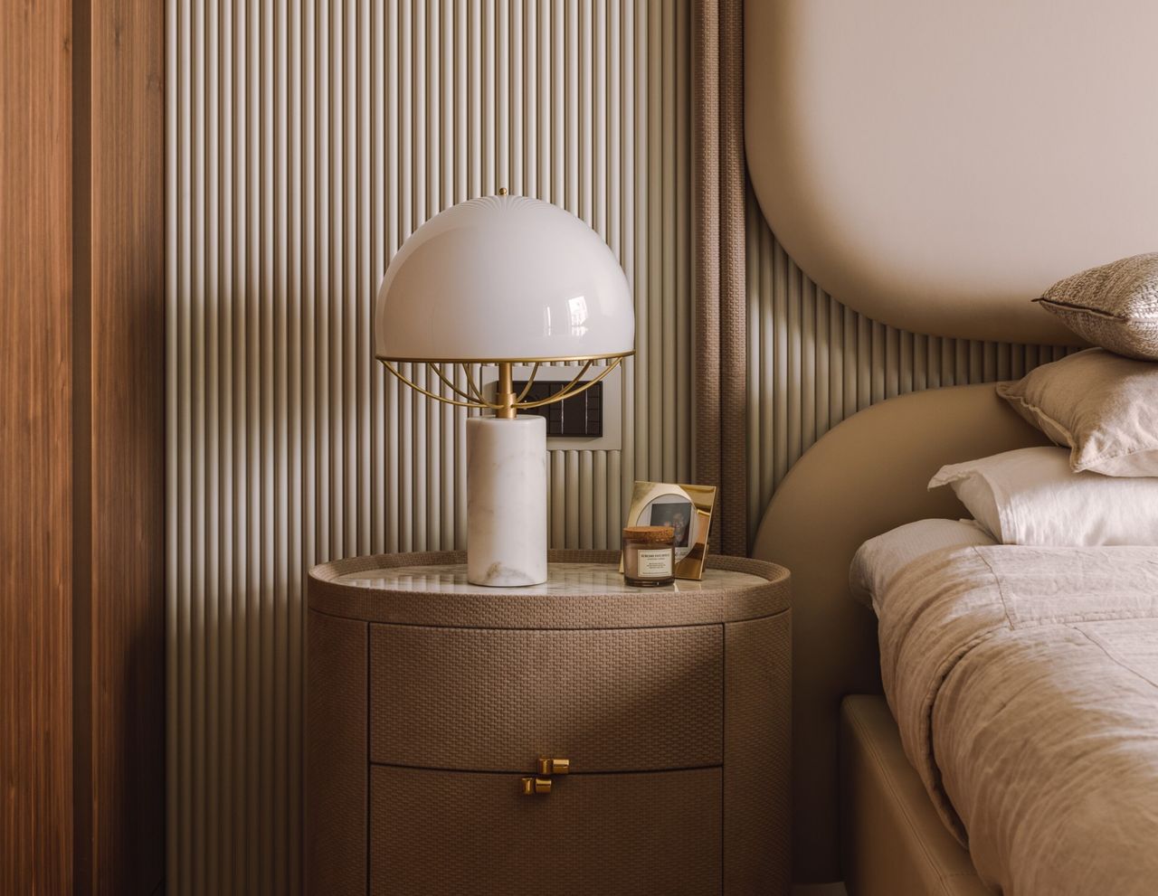 A bedside lamp in a neutral bedroom