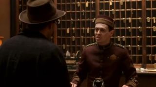 Steve Buscemi dressed as a hotel porter at the front desk in Barton Fink