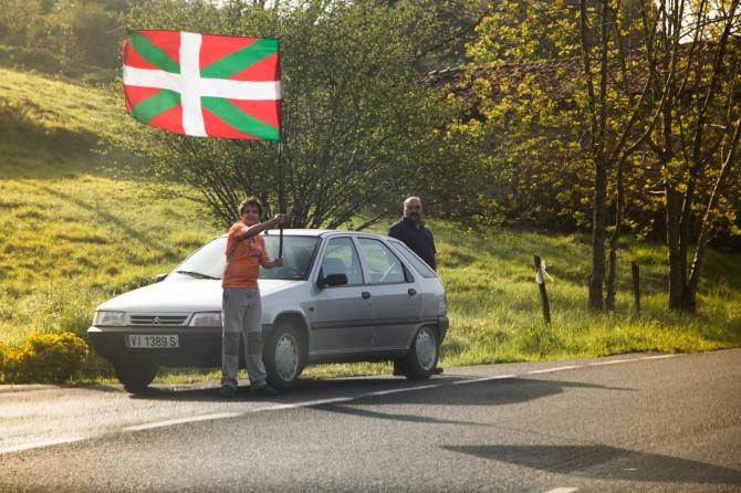 A young fan proudly waves the Euskadi flag