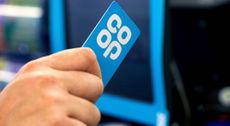 A person using the co-op membership card at a checkout