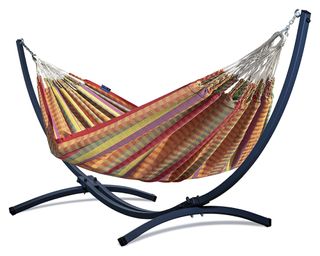 A multicoloured hammock with a balck metal freestanding hammock stand