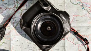 The Canon EOS R3 camera resting on a map