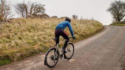 Image shows a person riding a bike that's equipped with some of the best bike fenders / mudguards
