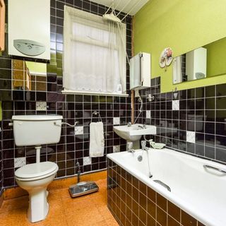 bathroom with bathtub and commode with wash basin