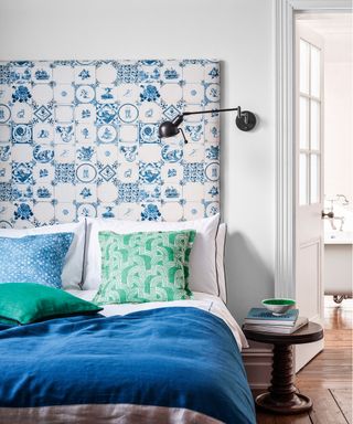 A blue and white patterned bed headboard against a white wall.