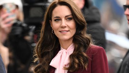 Princess Kate in Boston wearing a wine red suit with a pink blouse