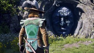 A medieval hero from Fable in green and brown stands before a cracked stone wall carved with the PlayStation logo, glowing Xbox emblem on their back amid grass and yellow flowers.